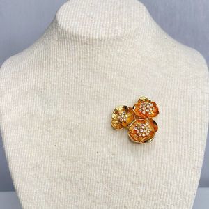 Flower Brooch Textured Gold Tone Petals With Central Clear Rhinestones